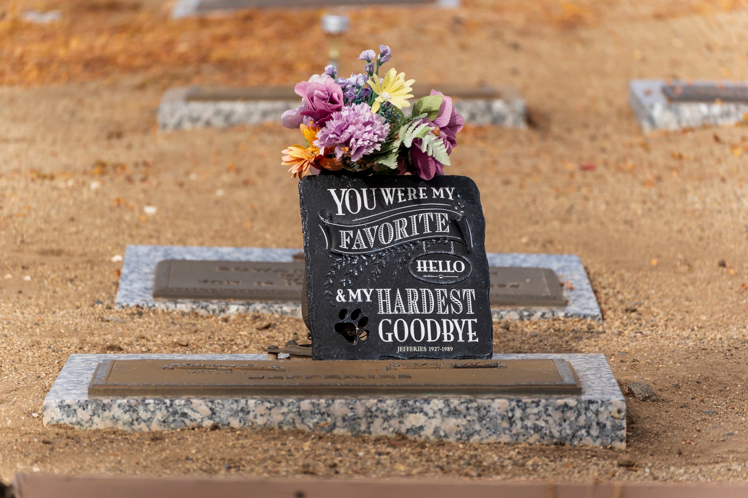 An engraved memorial keepsake with flowers