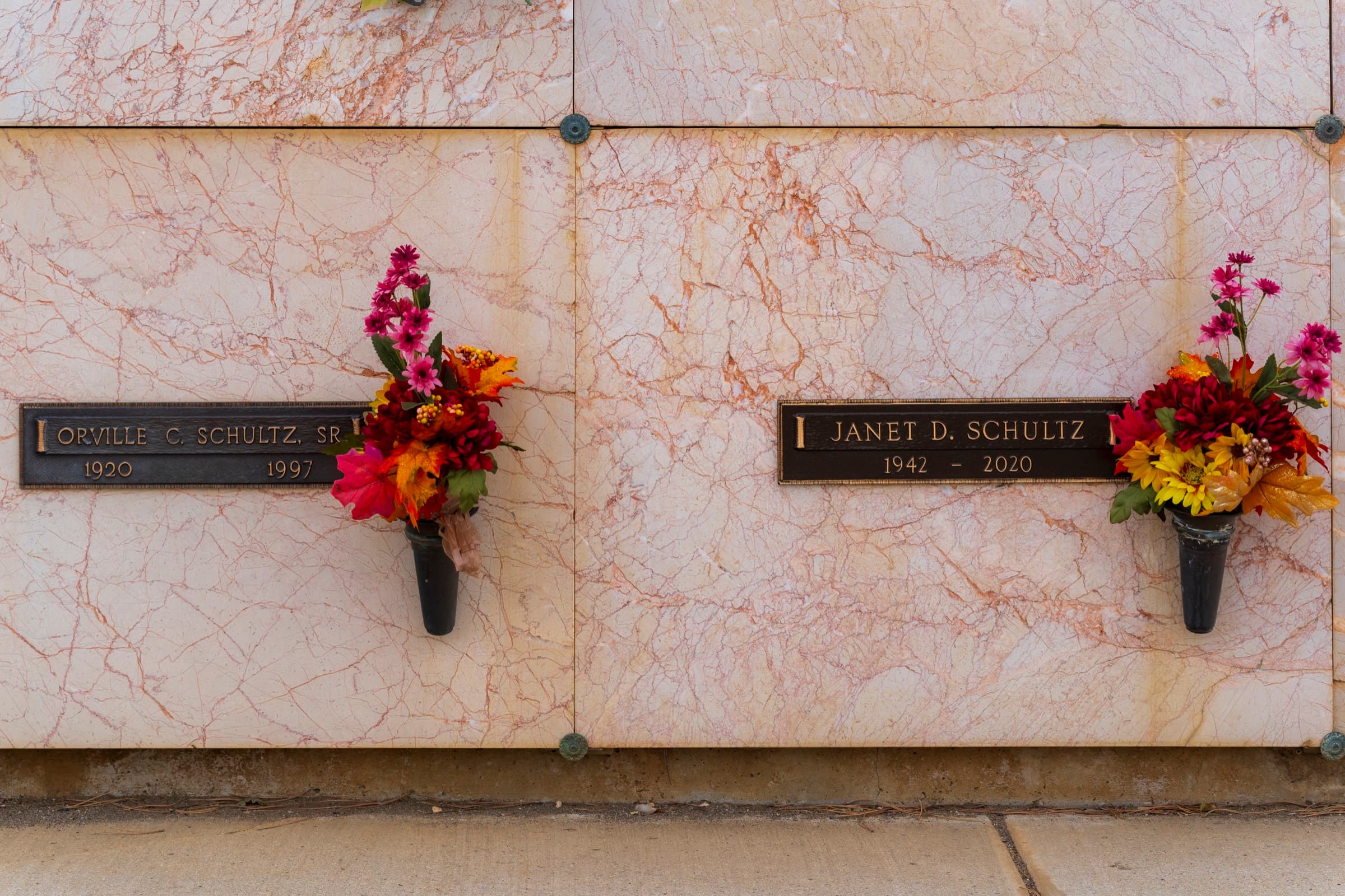 Bronze memorial plaques on a polished marble wall